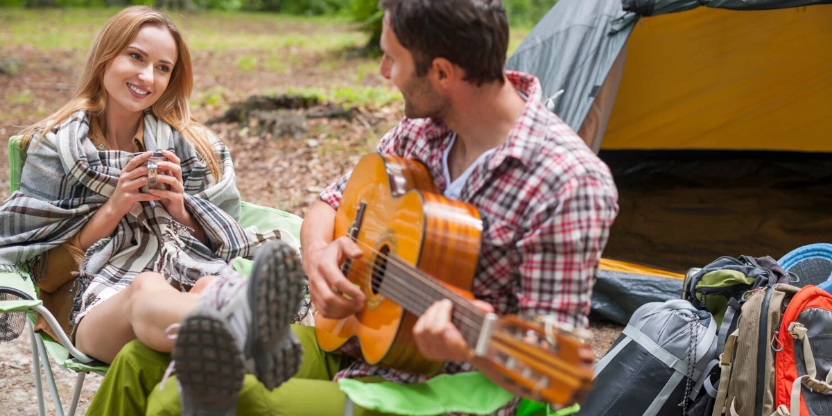 Man playing guitar to woman
